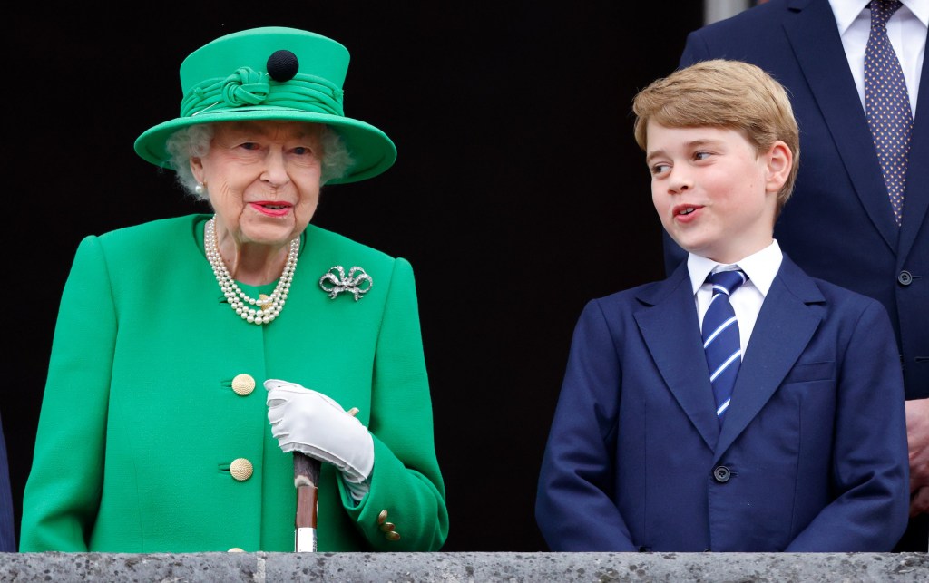 Queen Elizabeth II and Prince George of Cambridge stand on the balcony of Buckingham Palace following the Platinum Pageant