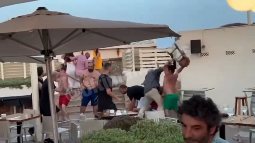 A man can be seen lifting a bar stool above his head during the brawl in Palm
